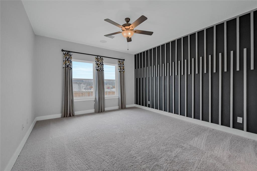 1902 Aleia Cove Sherman, TX 75092 - Photo 10 of 25 an empty room with ceiling fan and windows