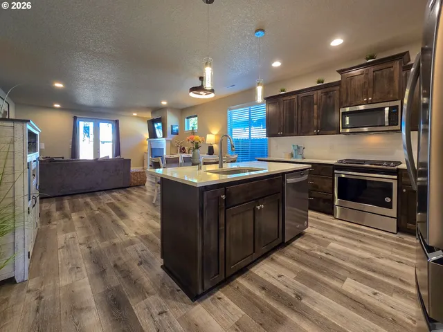 a kitchen with a sink stove and cabinets