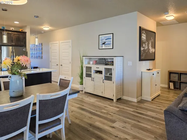 a dining room with furniture and wooden floor