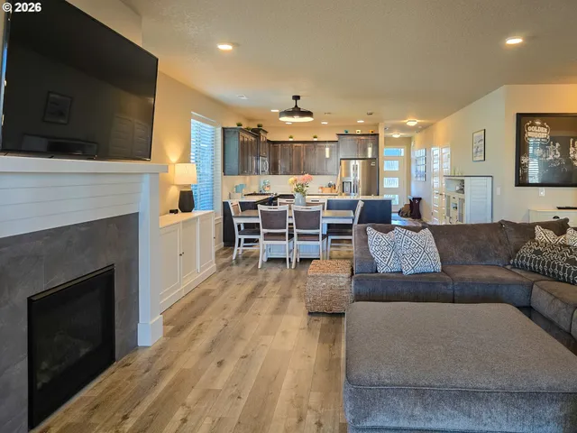 a living room with furniture fireplace and flat screen tv