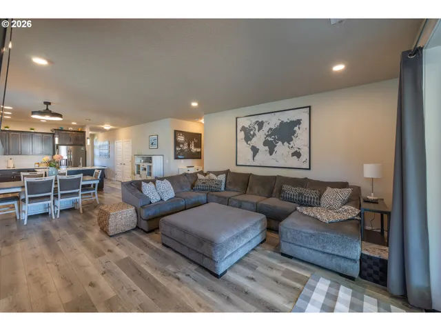 a living room with furniture and kitchen view