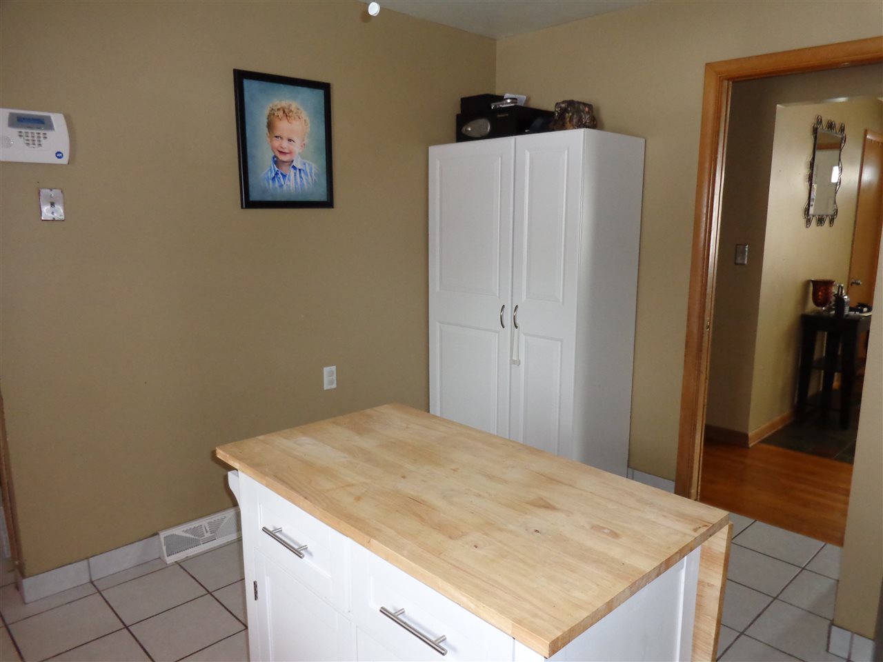 5240 Welsh Road Rockford, IL 61107 - Photo 18 of 25 a room with a wooden floor and a refrigerator