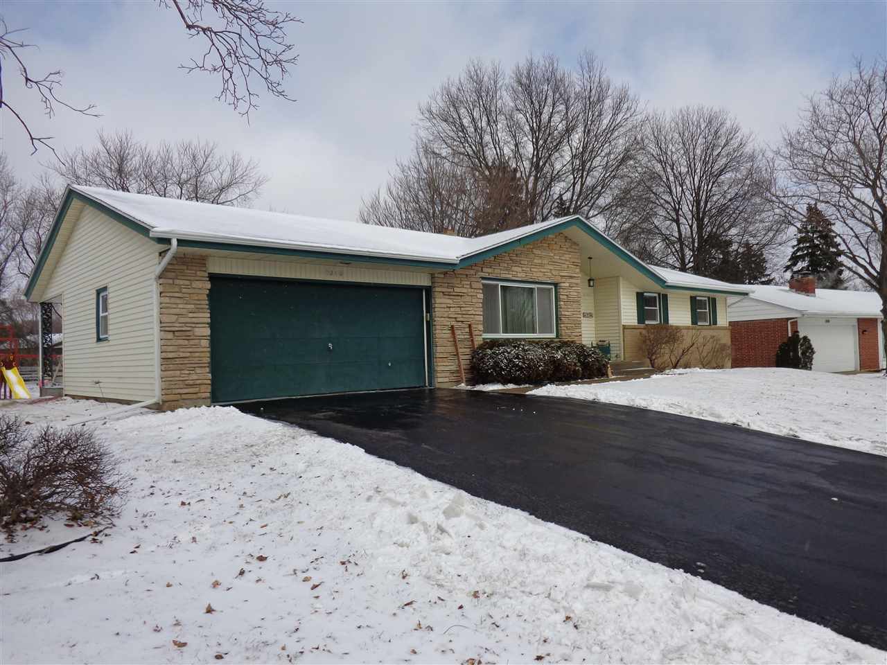 5240 Welsh Road Rockford, IL 61107 - Photo 3 of 25 a front view of a house with a yard and garage
