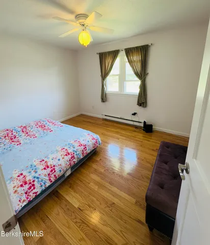 a bedroom with a bed dresser and a window