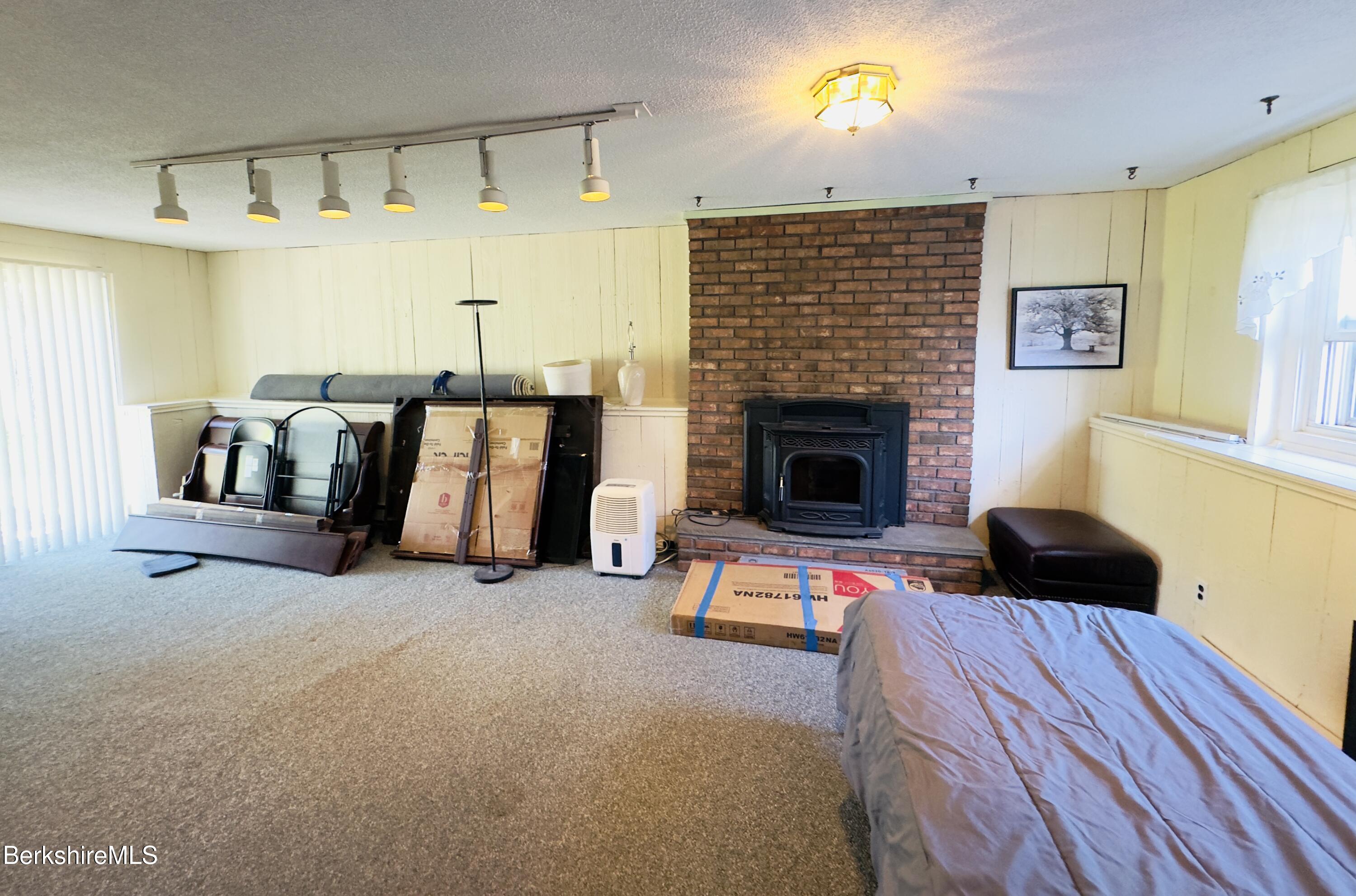127 Oak Hill Road Pittsfield, MA 01201 - Photo 21 of 22 a living room with furniture and a fireplace