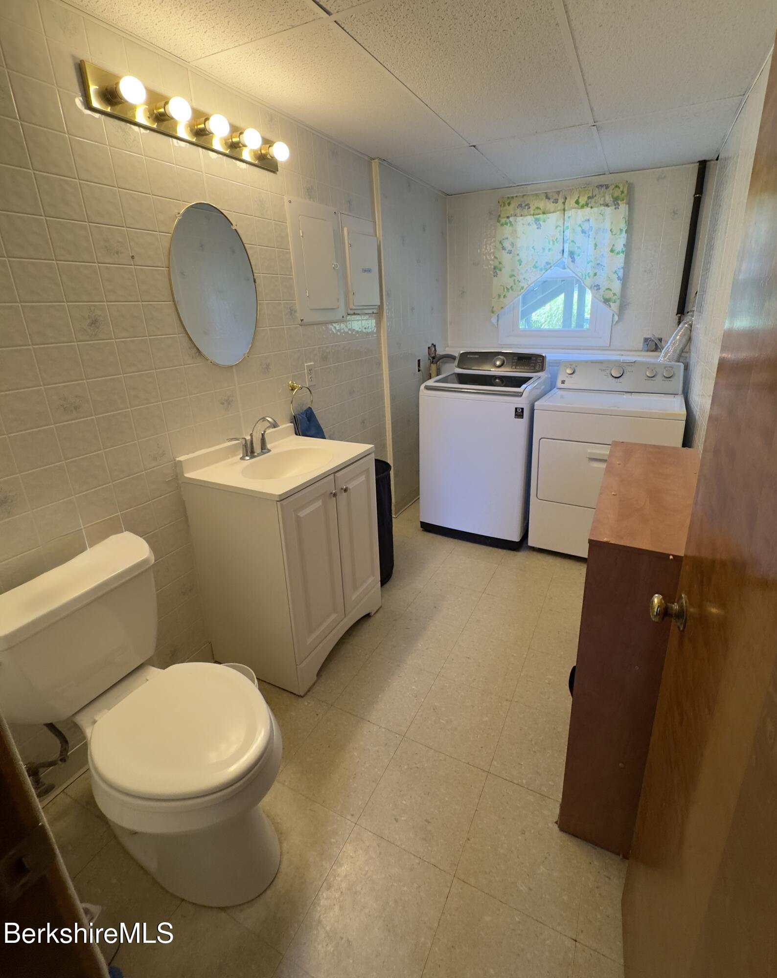 127 Oak Hill Road Pittsfield, MA 01201 - Photo 22 of 22 a bathroom with a granite countertop sink mirror vanity and toilet