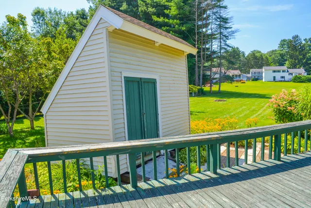 a view of a balcony with wooden floor & fence