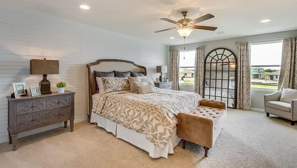 a bed room with a bed and a large window