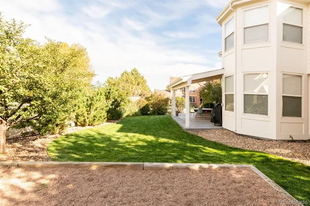 a view of a patio with a table chairs and a garden