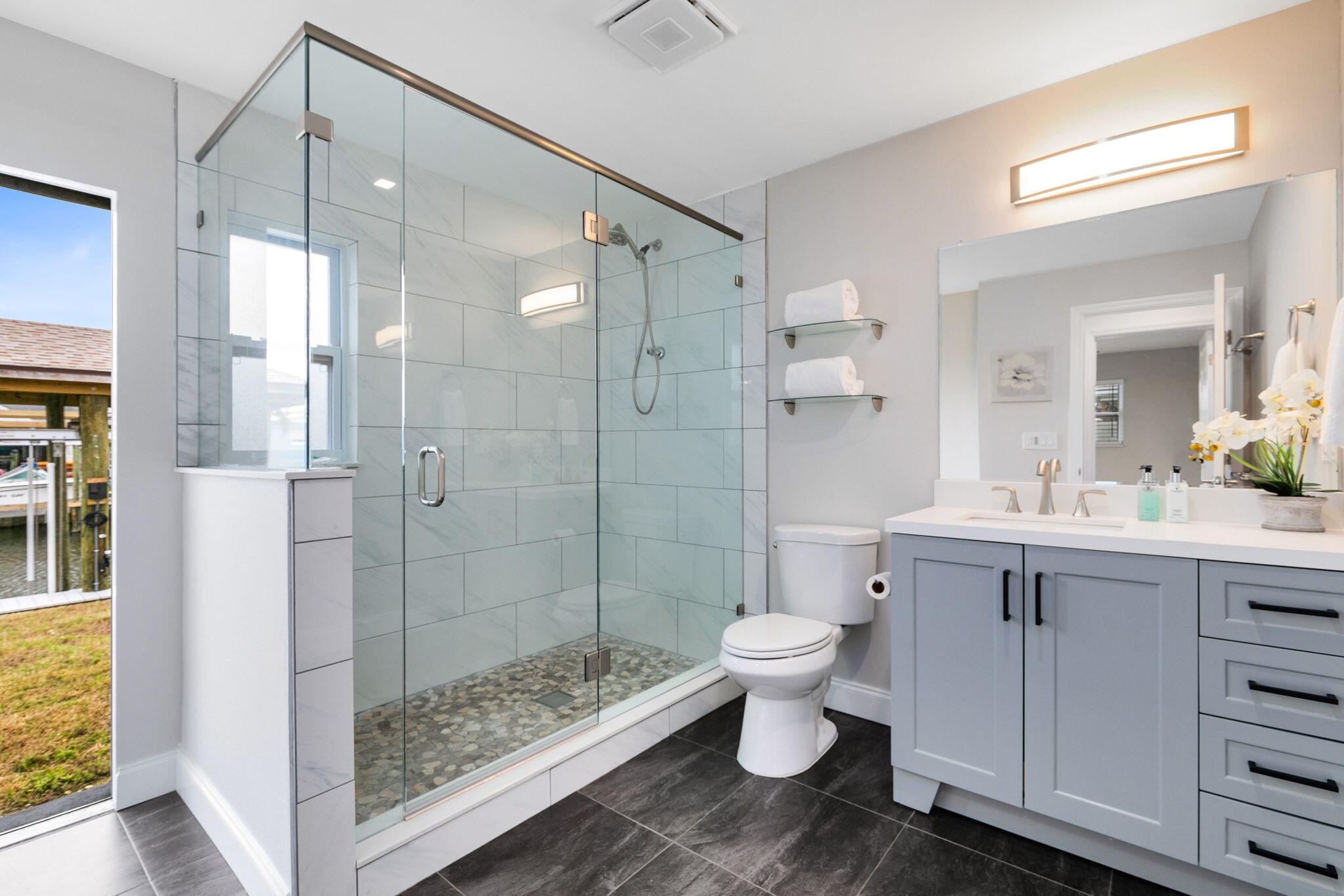 1700 Rochelle Parkway Merritt Island, FL 32952 - Photo 21 of 35 a bathroom with a shower toilet sink and mirror