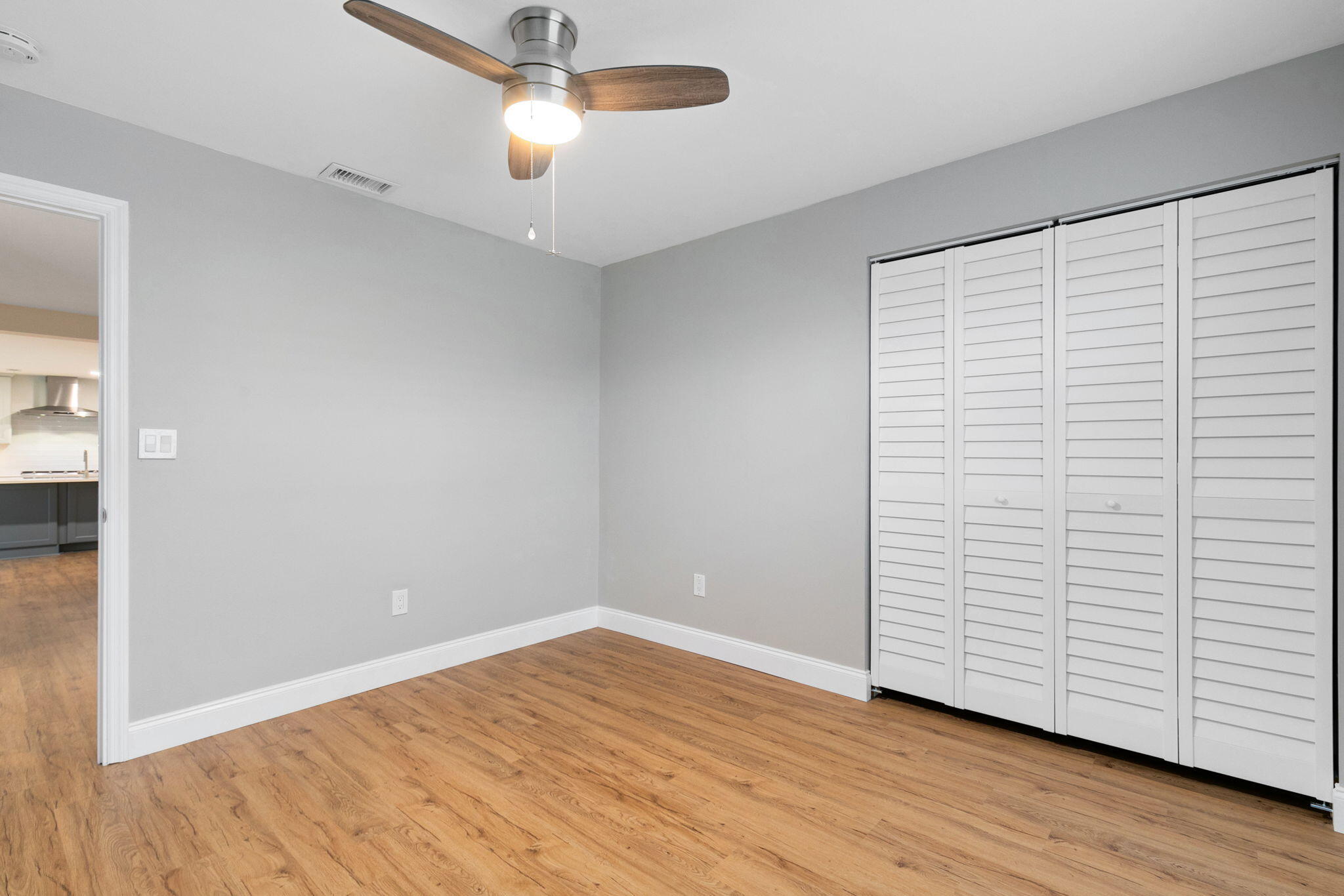 1700 Rochelle Parkway Merritt Island, FL 32952 - Photo 22 of 35 an empty room with wooden floor closet and windows