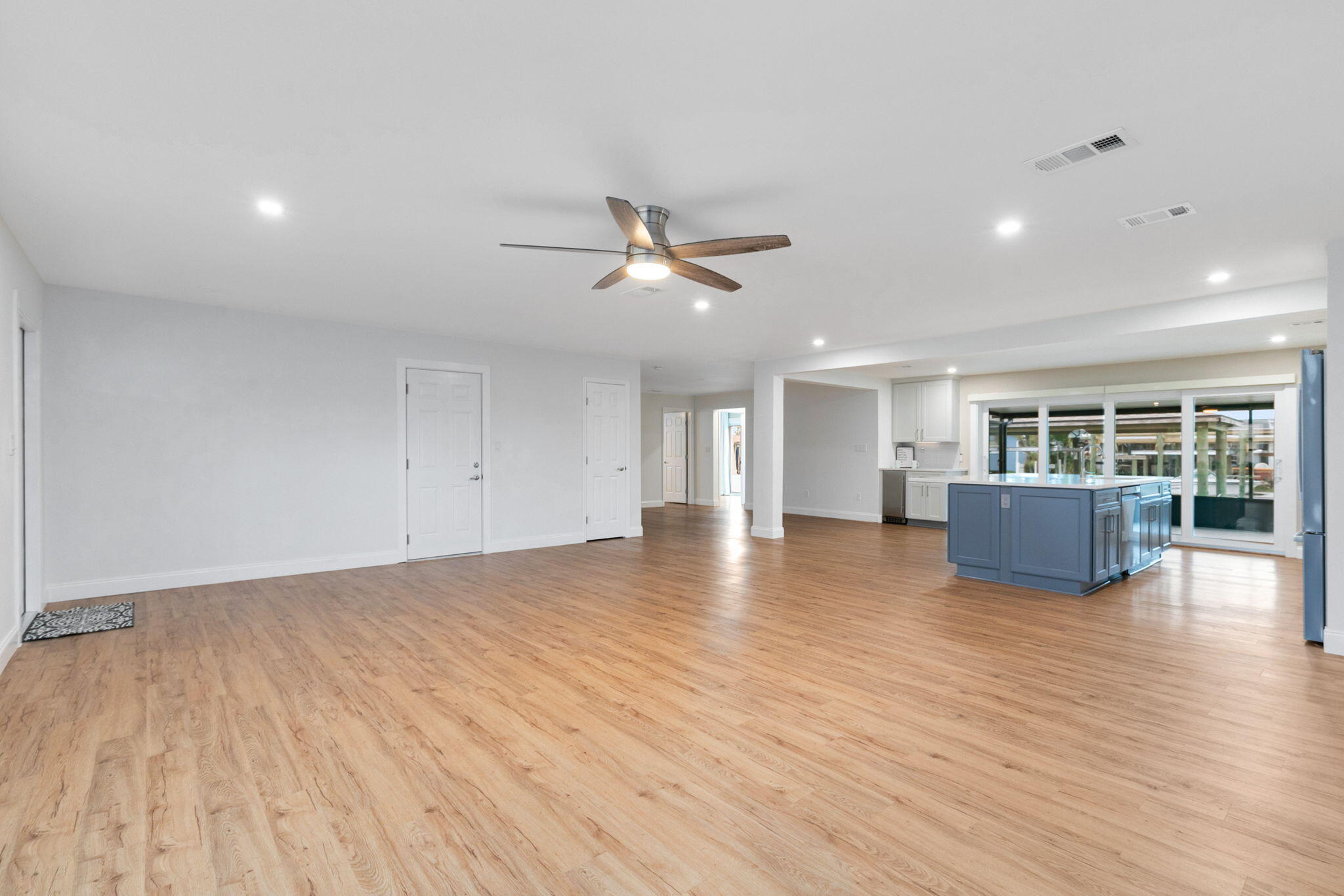 1700 Rochelle Parkway Merritt Island, FL 32952 - Photo 9 of 35 an empty room with wooden floor and a ceiling fan