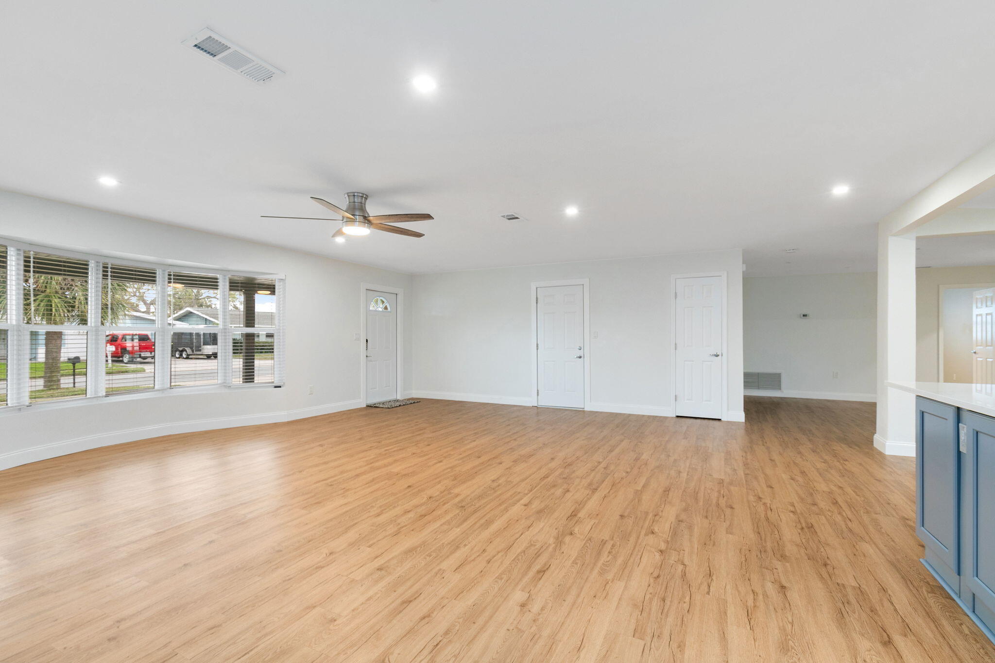 1700 Rochelle Parkway Merritt Island, FL 32952 - Photo 10 of 35 an empty room with wooden floor and natural light