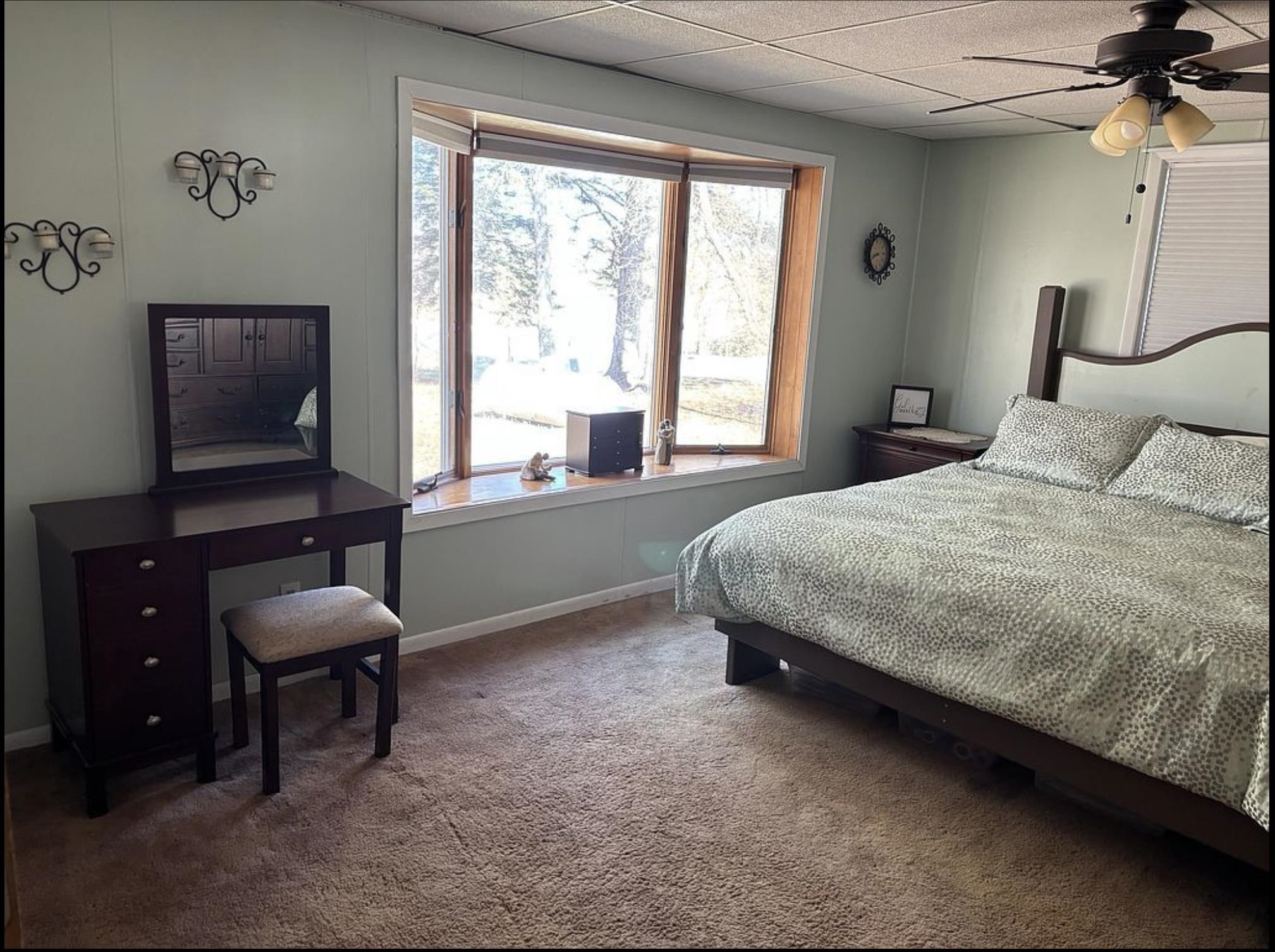 201 Golf Course Lane Bigfork, MN 56628 - Photo 17 of 30 Carpeted bedroom featuring bay window, baseboards, and ceiling fan