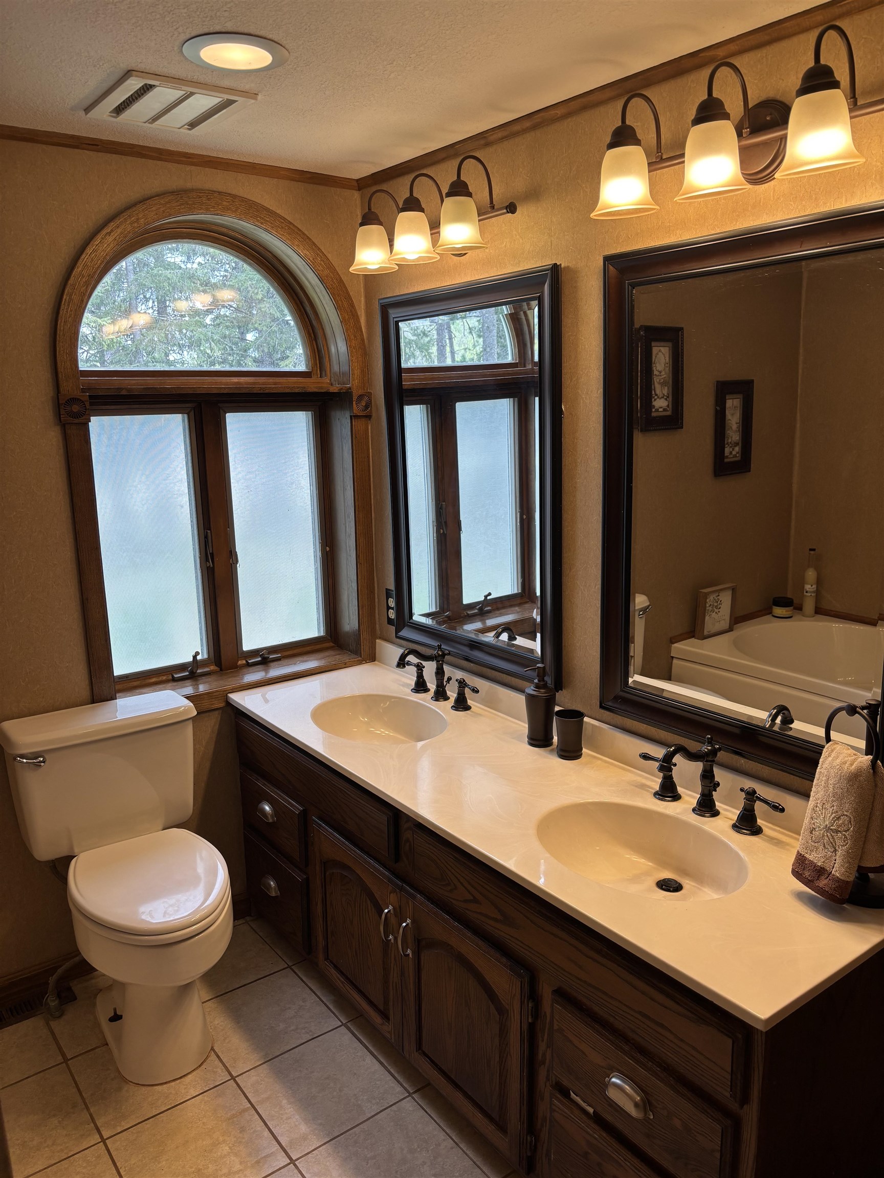 201 Golf Course Lane Bigfork, MN 56628 - Photo 19 of 30 Full bath featuring toilet, tile patterned flooring, double vanity, ornamental molding, and a bath