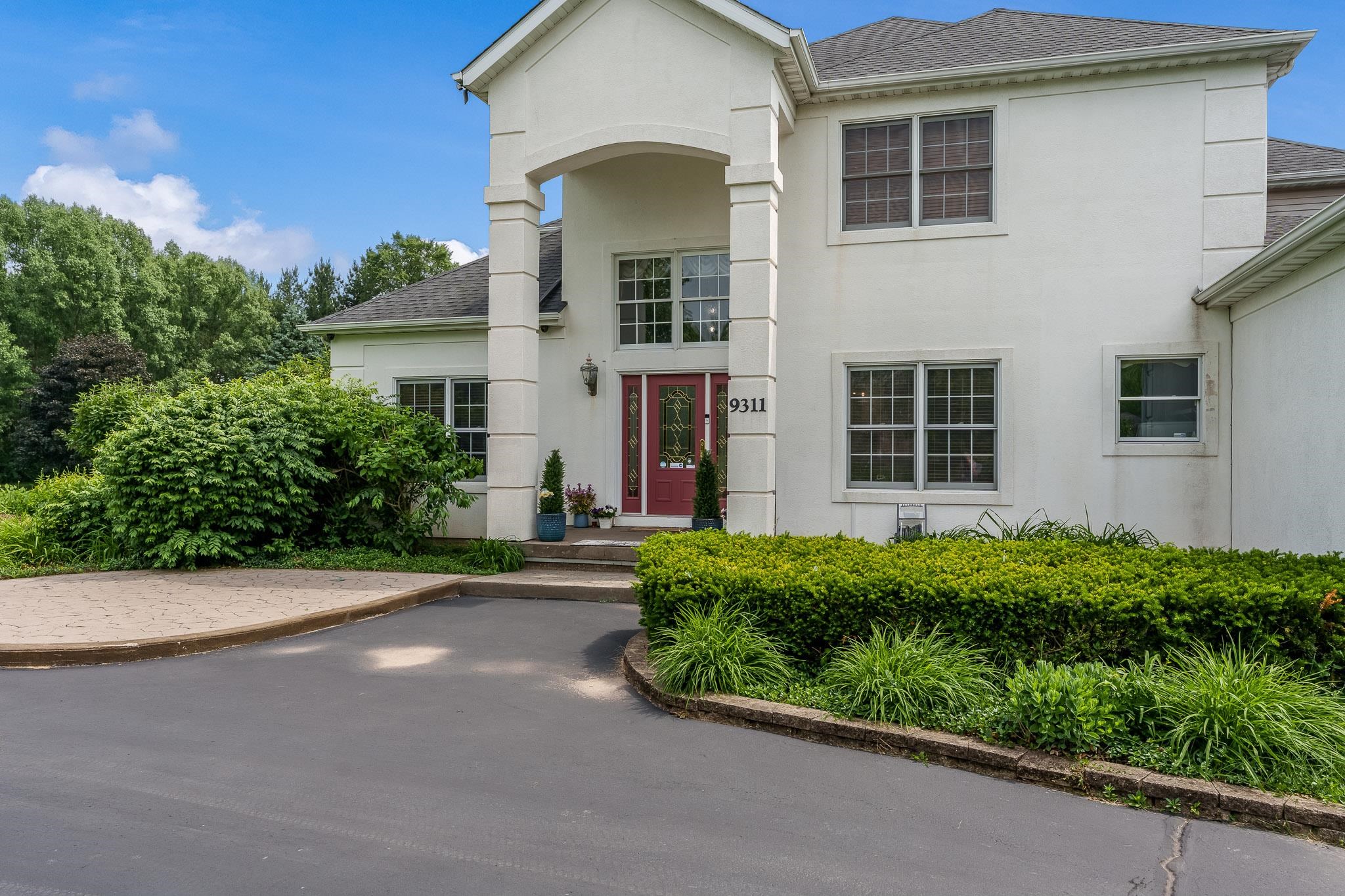 9311 Ridgeview Road Belvidere, IL 61008 - Photo 16 of 89 a view of a house with potted plants and a garage