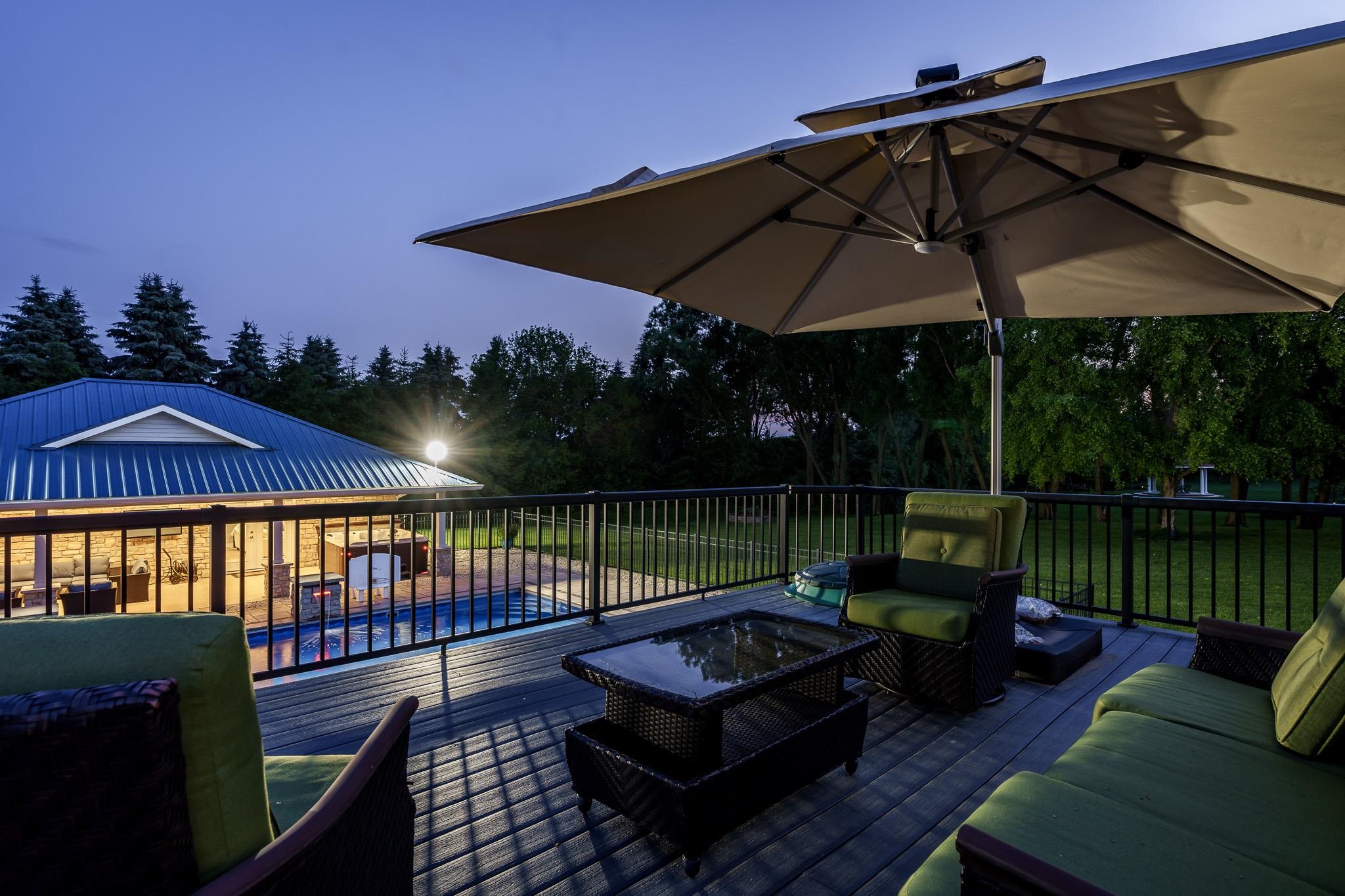 9311 Ridgeview Road Belvidere, IL 61008 - Photo 8 of 89 a view of a roof deck with couches under an umbrella