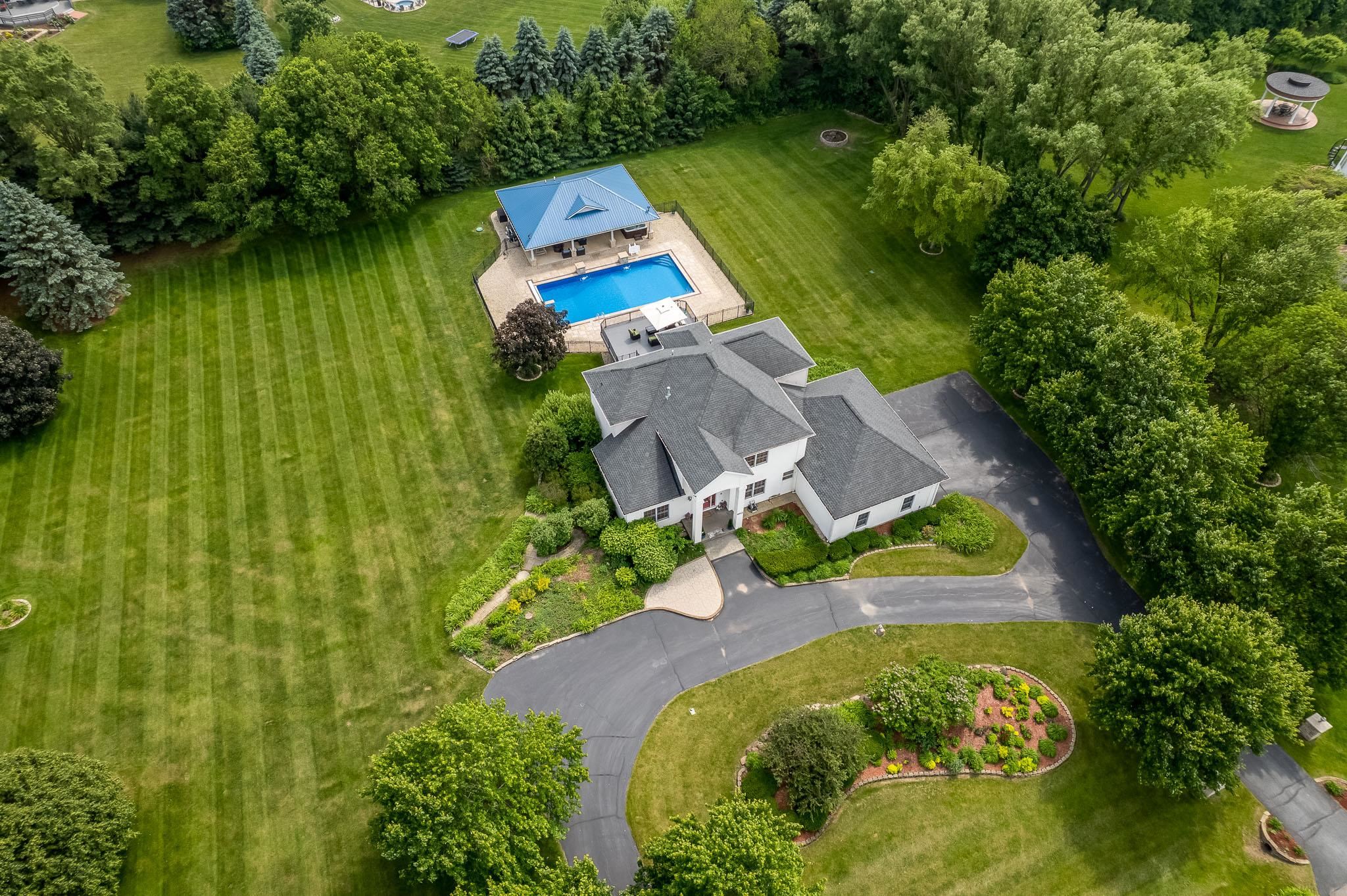 9311 Ridgeview Road Belvidere, IL 61008 - Photo 82 of 89 an aerial view of a house with a yard and swimming pool