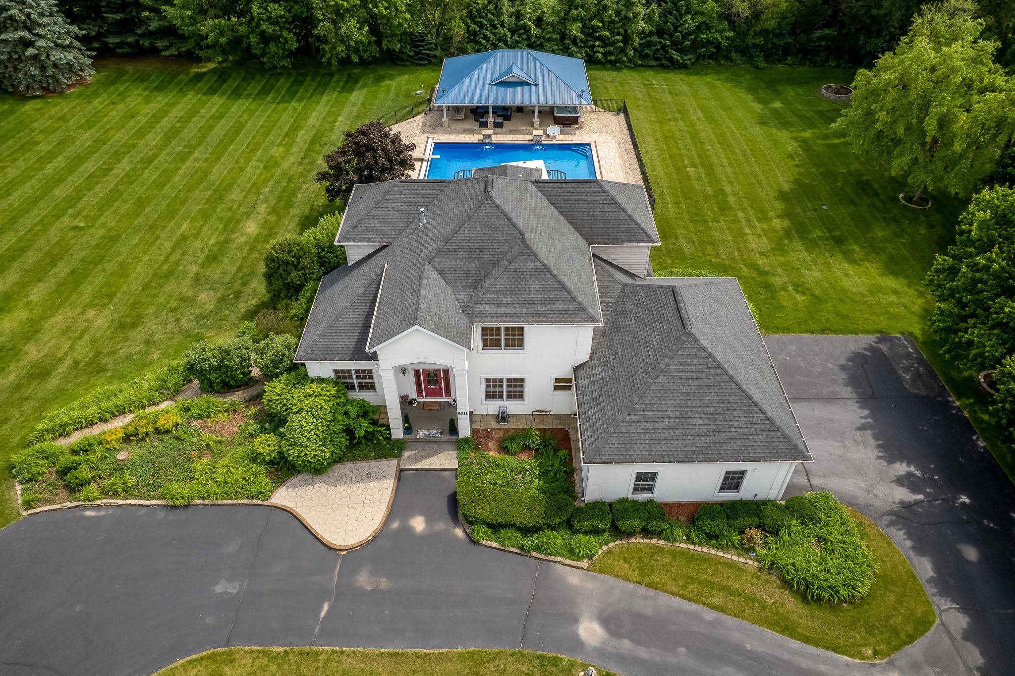 9311 Ridgeview Road Belvidere, IL 61008 - Photo 83 of 89 an aerial view of a house with swimming pool and garden