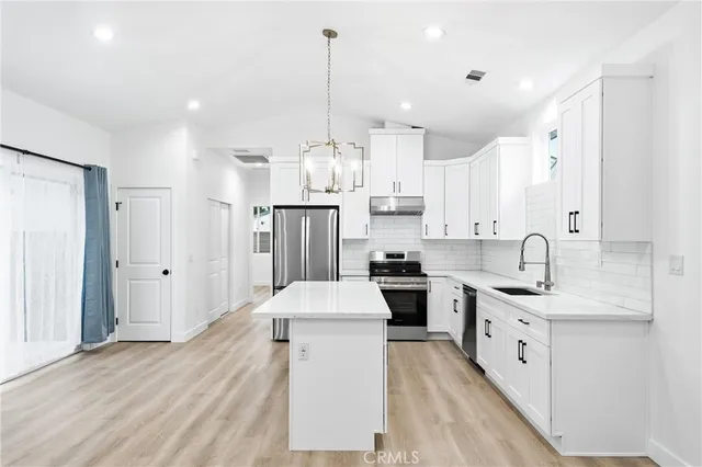 a kitchen with a sink stainless steel appliances and cabinets