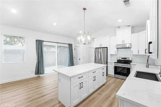 a kitchen with a sink cabinets and appliances