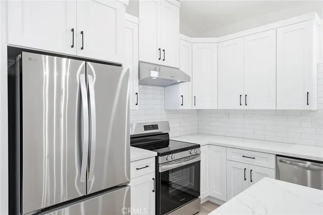 a kitchen with a sink cabinets and wooden floor