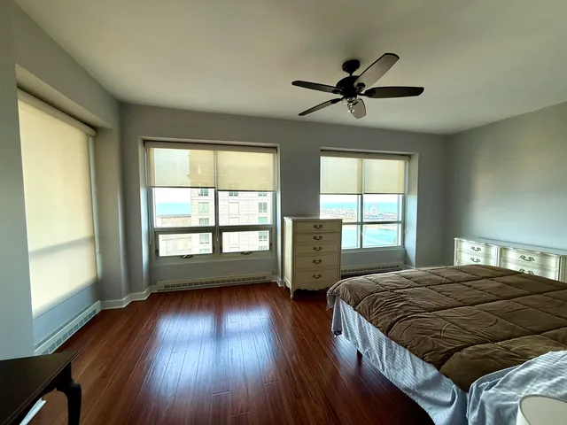 a bedroom with a bed and a large window
