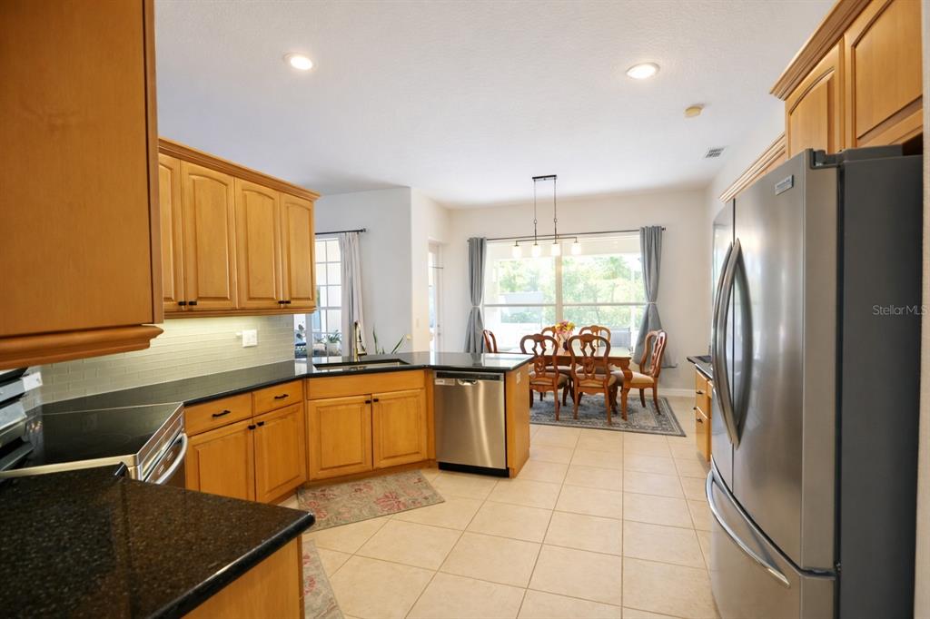 2009 Meadow Rue Court Trinity, FL 34655 - Photo 5 of 21 a kitchen with granite countertop a refrigerator and a sink