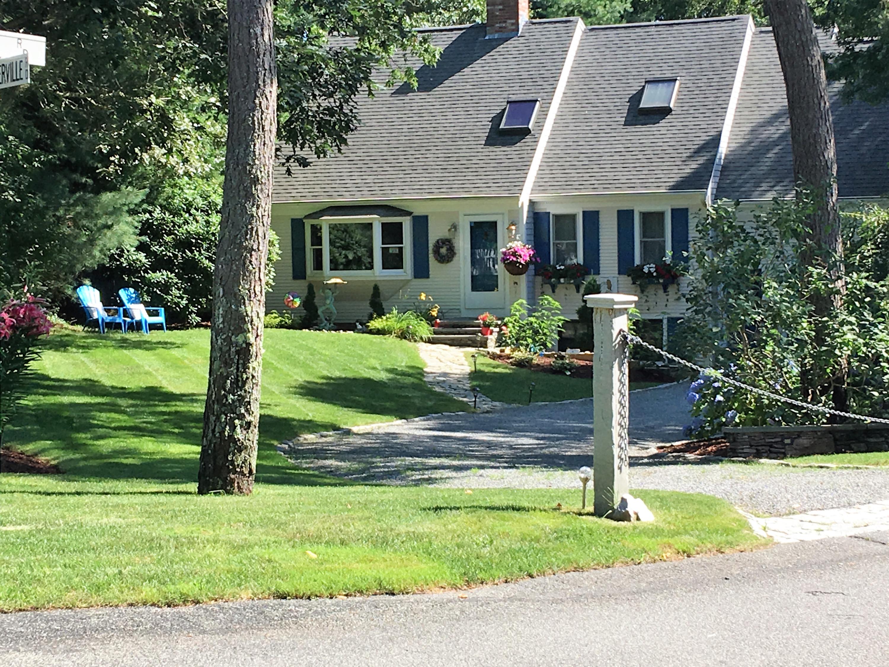 233 Oldham Road Osterville, MA 02655 - Photo 1 of 35 a front view of house with a garden and trees