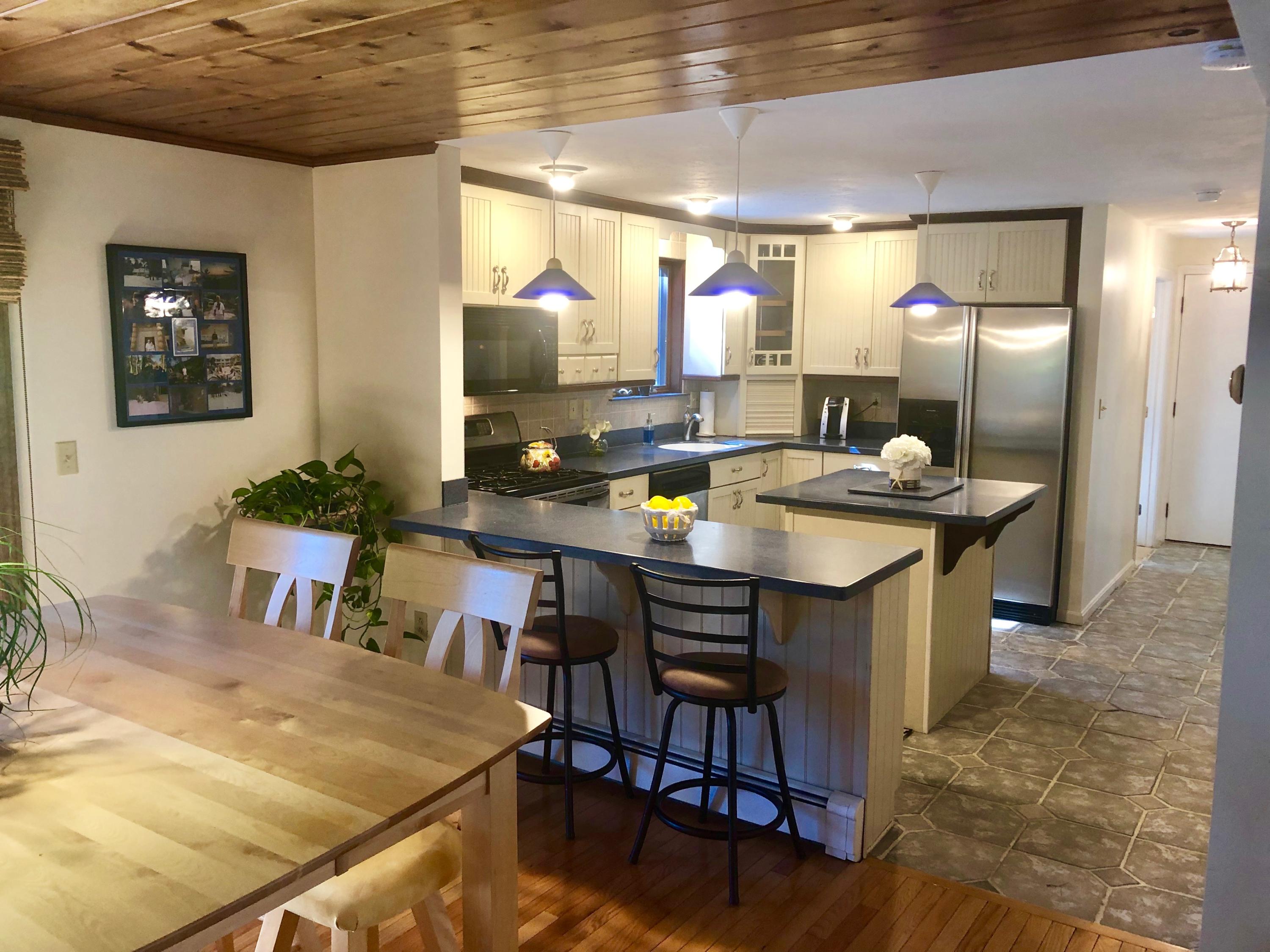233 Oldham Road Osterville, MA 02655 - Photo 14 of 35 a kitchen with a table chairs and a refrigerator