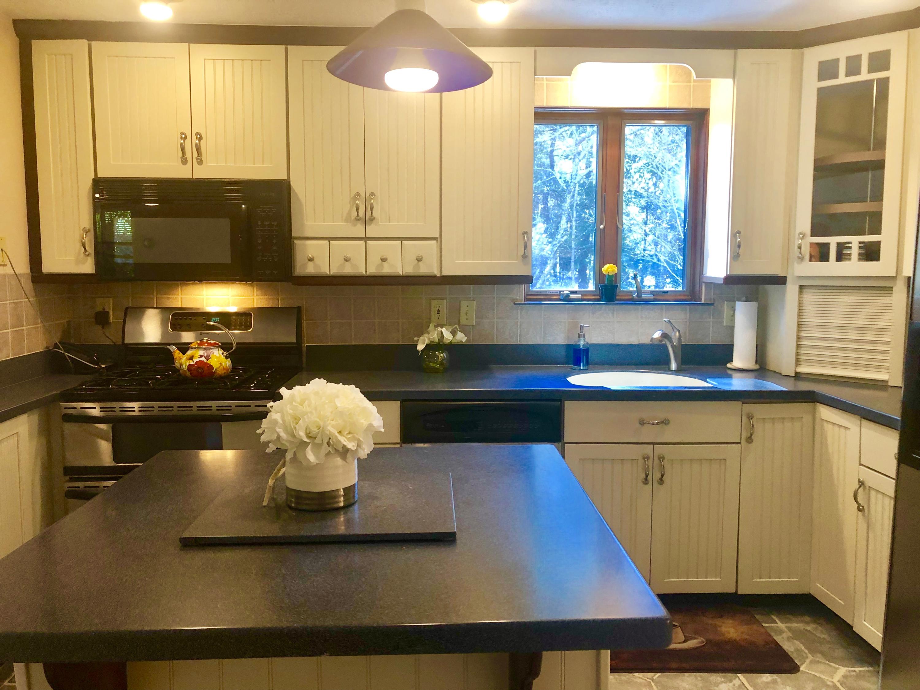 233 Oldham Road Osterville, MA 02655 - Photo 18 of 35 a kitchen with a sink appliances and cabinets