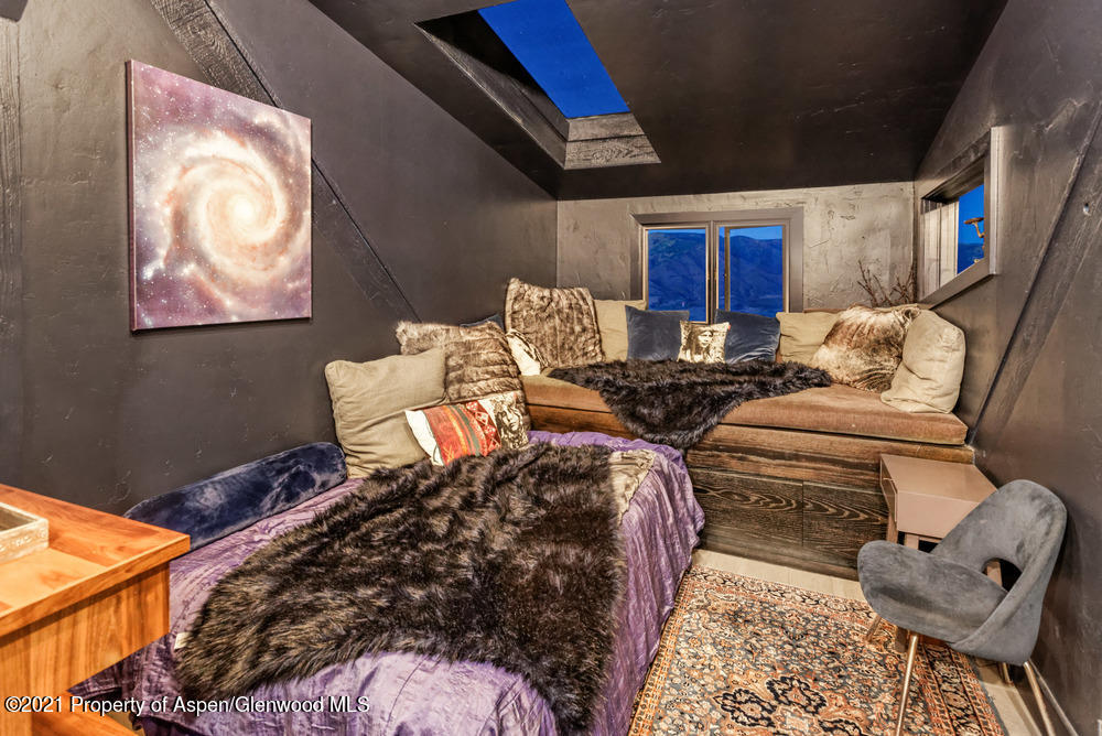 2661 Juniper Hill Road Aspen, CO 81611 - Photo 20 of 31 a bedroom with furniture and a chair