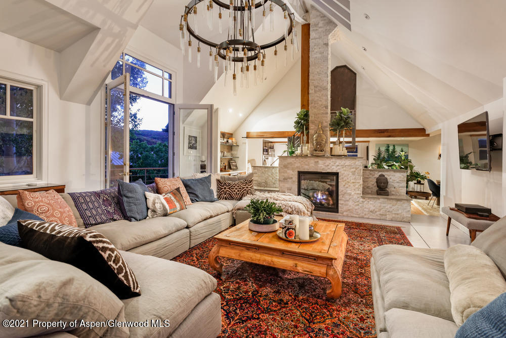 2661 Juniper Hill Road Aspen, CO 81611 - Photo 2 of 31 a living room with furniture a fireplace and a flat screen tv