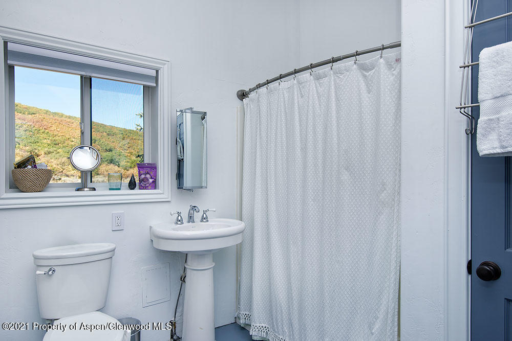 2661 Juniper Hill Road Aspen, CO 81611 - Photo 28 of 31 a bathroom with a sink a toilet and a mirror
