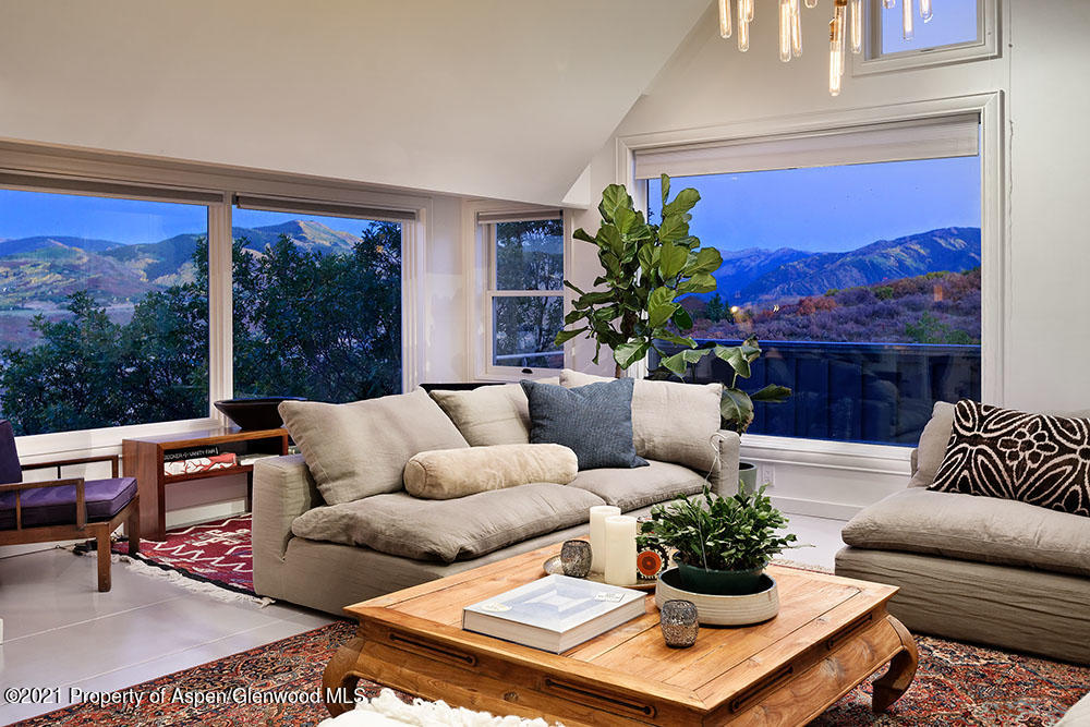 2661 Juniper Hill Road Aspen, CO 81611 - Photo 4 of 31 a living room with furniture potted plant and a large window
