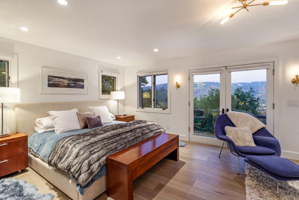 2661 Juniper Hill Road Aspen, CO 81611 - Photo 9 of 31 a bedroom with a bed and a large window