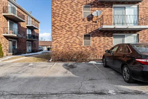 a car parked in front of a brick house