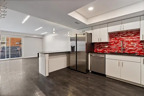 a kitchen with stainless steel appliances granite countertop a refrigerator and a sink