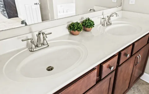 a view of a patio with table and chairs under an umbrella with a small yard