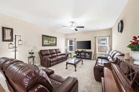 a kitchen with stainless steel appliances granite countertop a refrigerator a stove top oven a sink dishwasher and a dining table with wooden floor