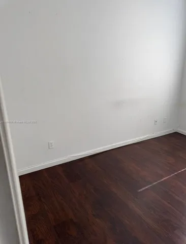 an empty room with wooden floor