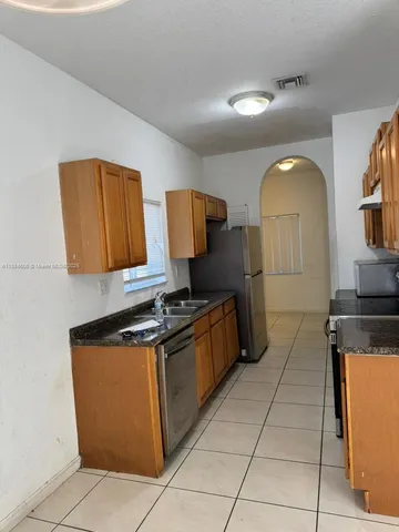 a kitchen with stainless steel appliances granite countertop a stove and a sink