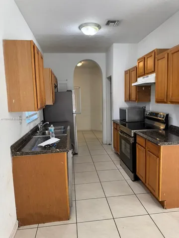a kitchen with stainless steel appliances granite countertop a sink and cabinets