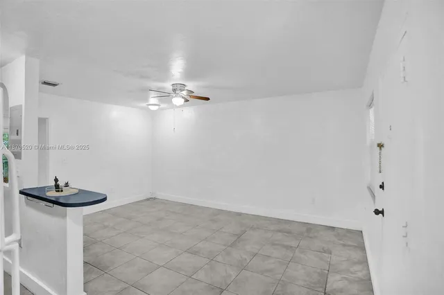 a view of a room with a sink and a mirror