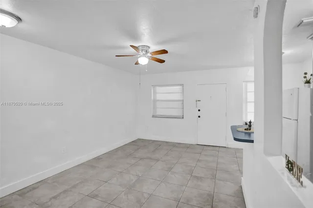 an empty room with closet and a chandelier fan