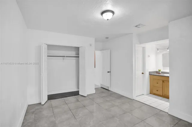 a view of a kitchen with a sink and a refrigerator