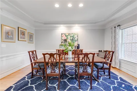a view of a dining room with furniture and a window
