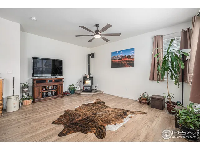 a living room with furniture and a flat screen tv with wooden floor
