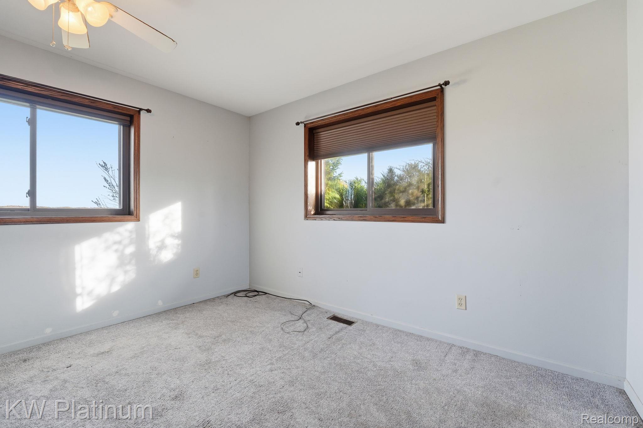 7383 Fisher Road Jeddo, MI 48032 - Photo 11 of 40 Unfurnished room with carpet floors and ceiling fan