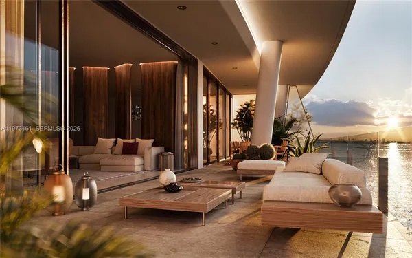 a living room with couches and kitchen view with wooden floor